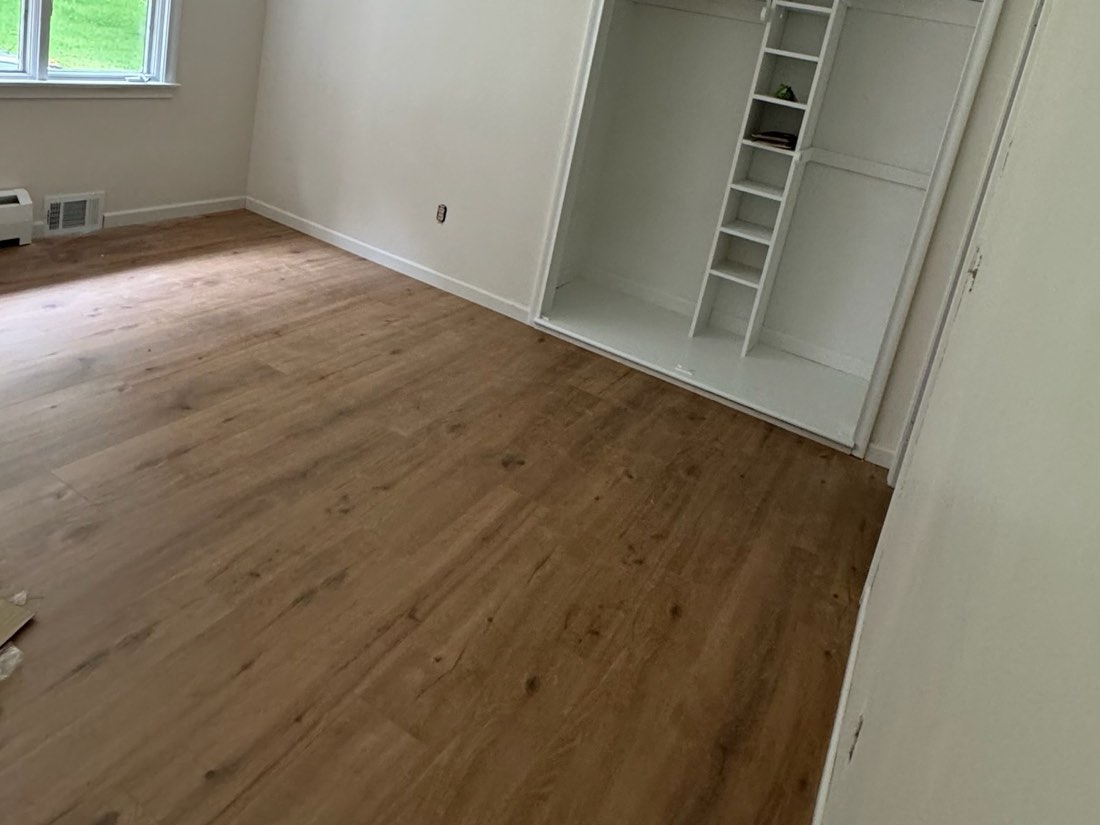 Piso laminado nuevo en un cuarto reci&eacute;n pintado con cl&oacute;set empotrado